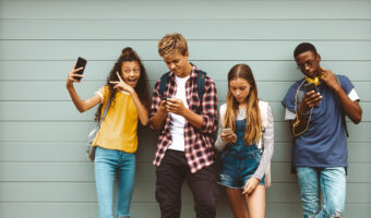 Teenage friends looking at their mobile phones